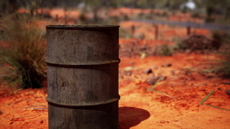 old empty rusted barrel on sand