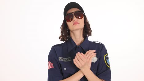 confident female police officer in uniform and sunglasses posing