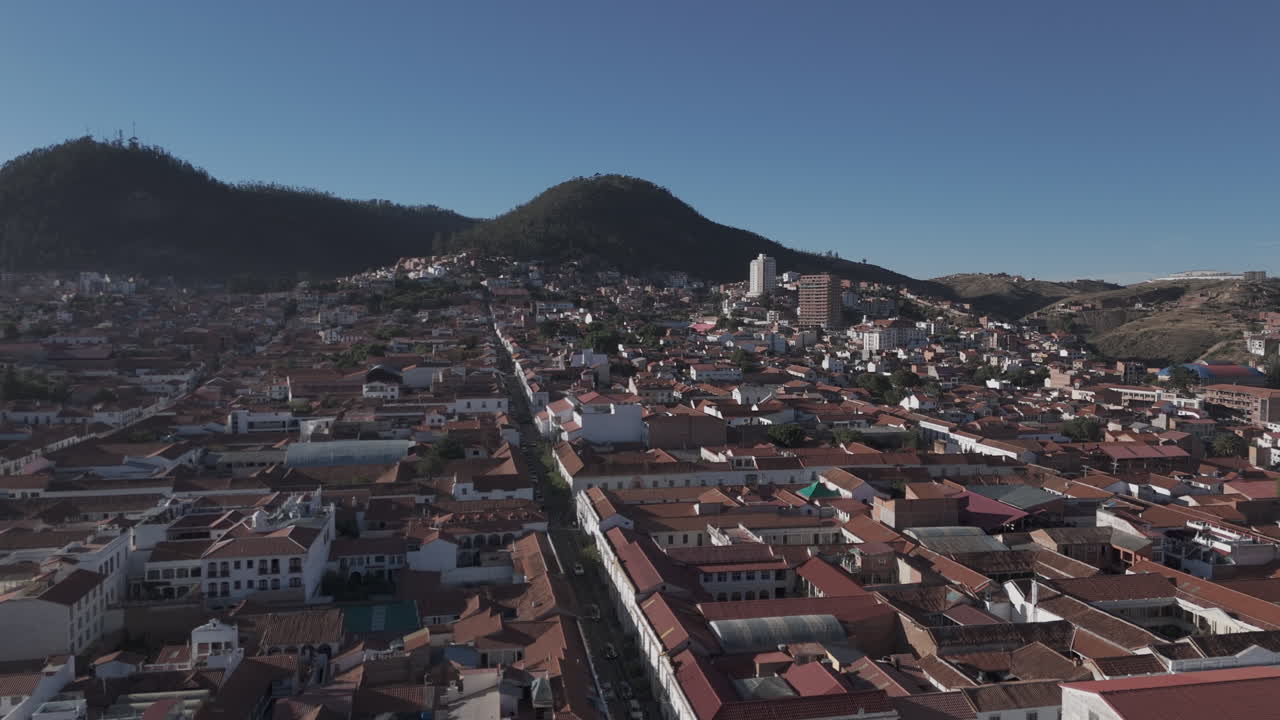 Drone shot above Sucre Bolivia on a sunny and bright day with an overview of the city and main square LOG