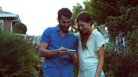 happy couple taking selfie in the garden