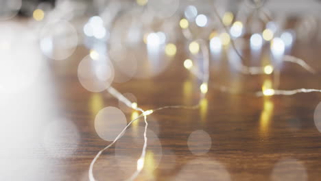 fairy lights glowing over bokeh animation on wooden surface