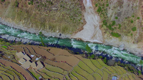 a river that runs usually in mountains, in narrow, deep valley with steep banks, rocky stream bed, and accumulated rock debris