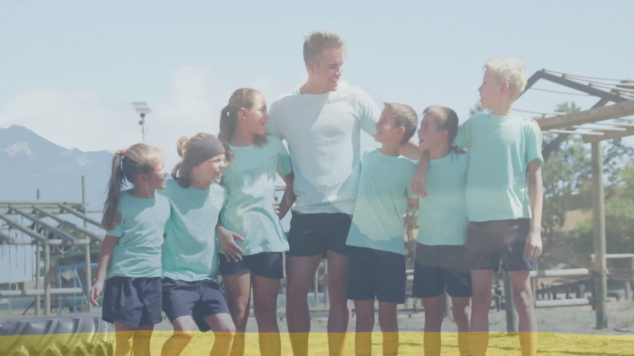 In school, children and adult creating animation together, smiling in sunny setting