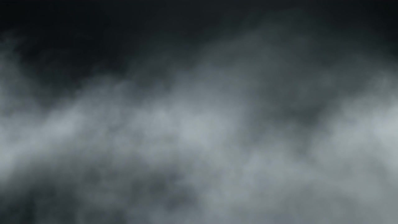 Thick White Smoke or Fog Swirling Against a Black Background