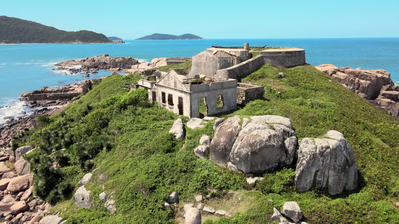 Aerial drone top scene of ruins of an ancient abandoned and isolated fortress on a desert island Fortaleza de Nossa Senhora da Conceição de Araçatuba Florianopolis Santa Catarina Brazil