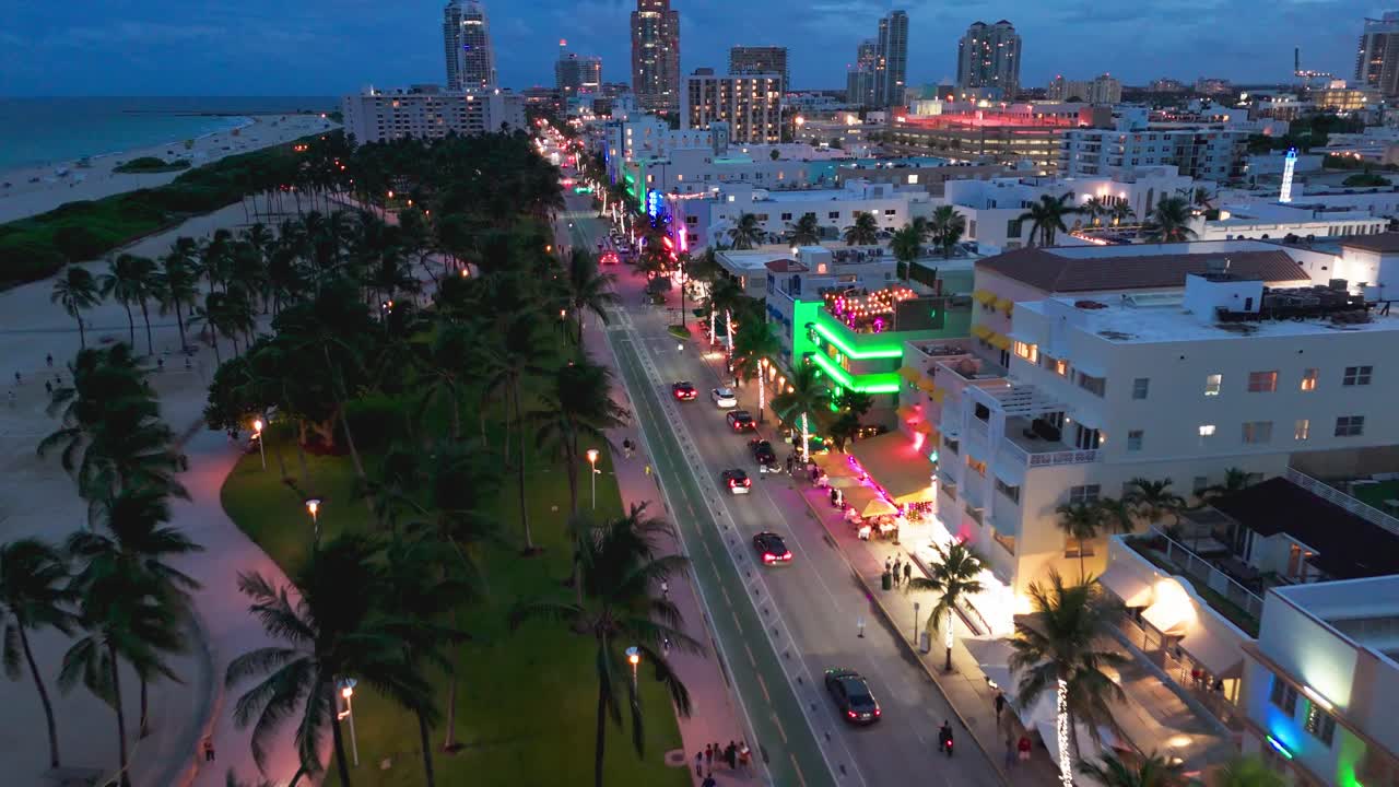 Drone shot of Ocean Drive at dusk with neon lights in Miami Beach