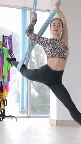 beautiful young woman doing aerial yoga or flying yoga pilates in a hammock professional yoga teac beautiful young woman doing aerial yoga or flying yoga pilates in a hammock professional yoga teacher practicing antigravity poses