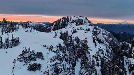 Paisaje-Escénico-De-Montañas-Y-árboles-Nevados,-Colorido-Cielo-Al-Atardecer