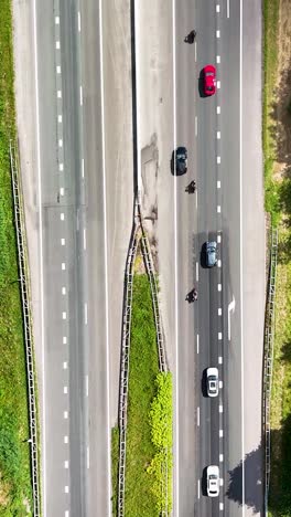 aerial drone view of highway traffic with cars and motorcycles