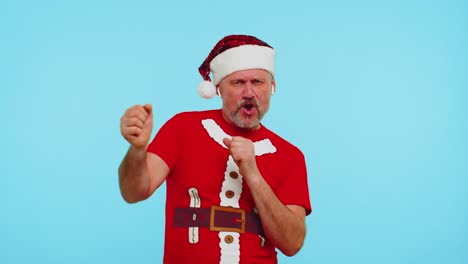Man-in-Christmas-t-shirt-listening-music-via-earphones,-dancing-disco-fooling-around-having-fun