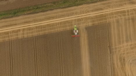 harvest drone follow combine harvester as it crops down a field