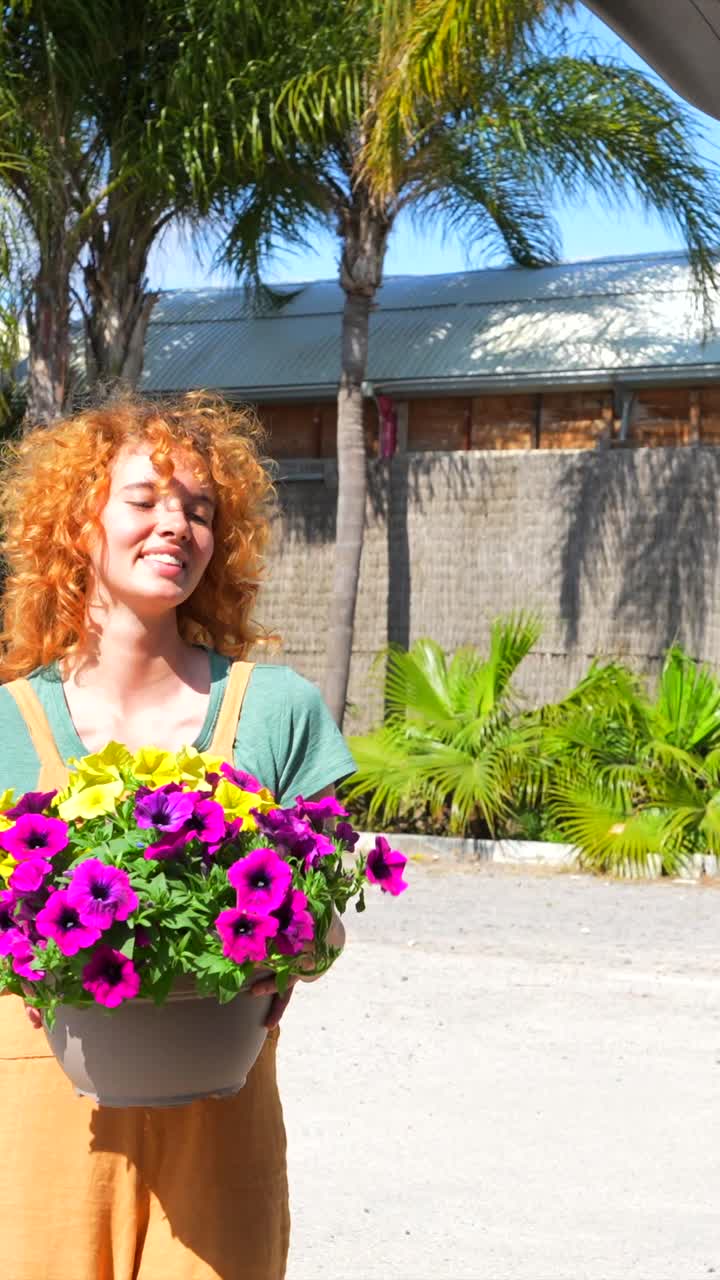 A woman with flower pots in a car trunk