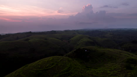 sunset scenery at teletubbies hill in nusa penida, bali, indonesia - aerial drone shot