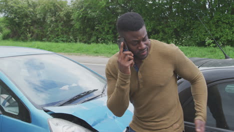 male driver involved in car accident calling insurance company from roadside