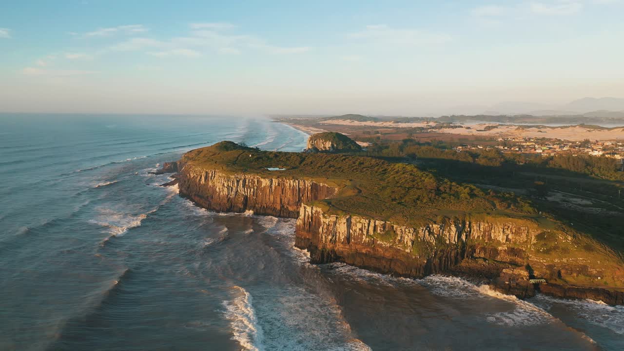 Drone aerial cinematic shot of rocky cliffs on atlantic ocean