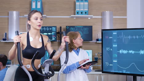 female scientist monitoring the heart activity on female athlete