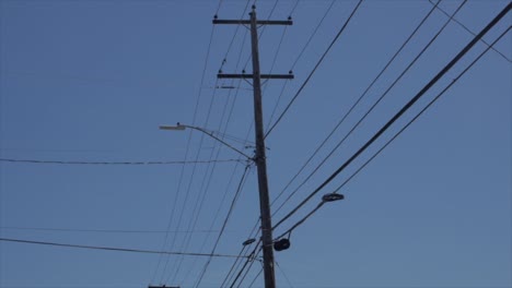 driving by city power lines with blue skies in background