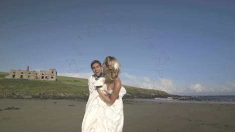 bride and groom on beach with geometric shapes animation over landscape