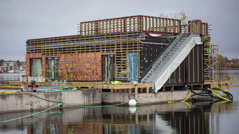 construction time lapse of a crew building a floating restaurant along the waterfront