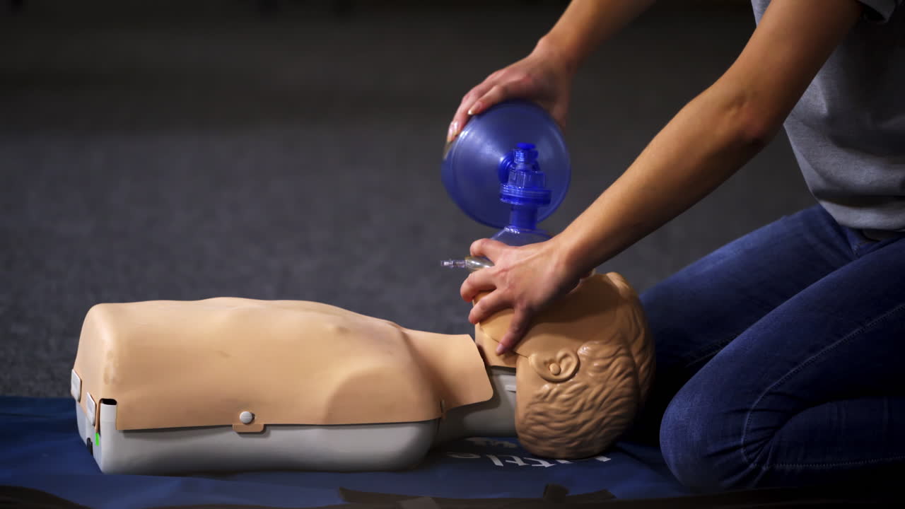 Resuscitation during first aid training. First aid instructor showing resuscitation technique on dummy