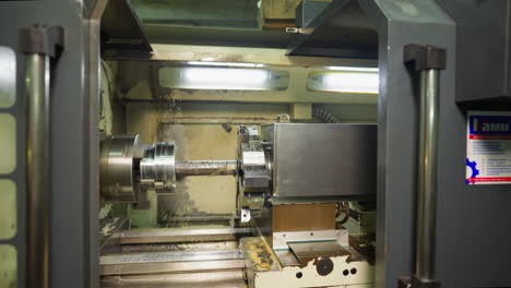 automated cnc lathe machining metal with precision in a well-lit industrial facility