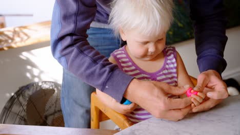 Father-and-daughter-playing-together-with-clay-in-a-comfortable-home-4k