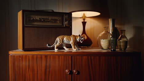 vintage radio, tiger figurine, and vases on a wooden cabinet