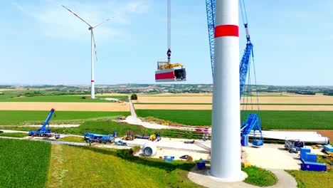 construction of windmill in green fields - drone shot