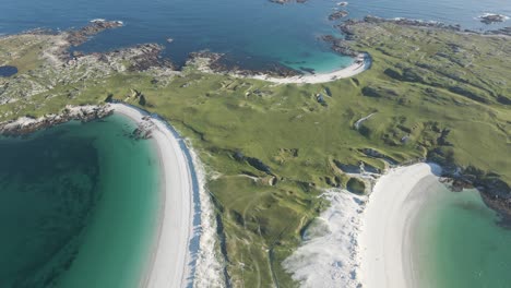 flying over the dog's bay beach with the gurteen beach on a sunny summer day by the lush green meadow in roundstone, county galway, connemara, ireland