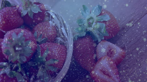 basket of strawberries with snowflake animation overlaying scene in winter setting