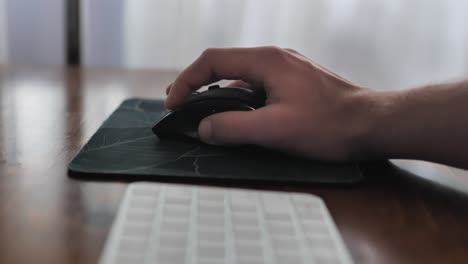 Hand-working-on-pc-mouse-on-control-panel-desk