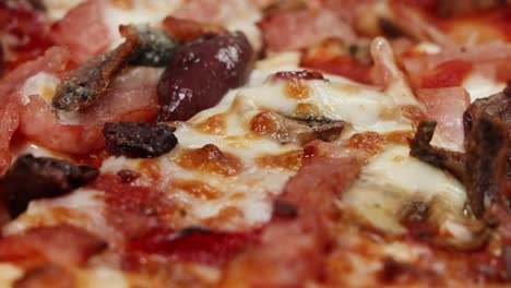 close-up of a pizza as cheese melts.