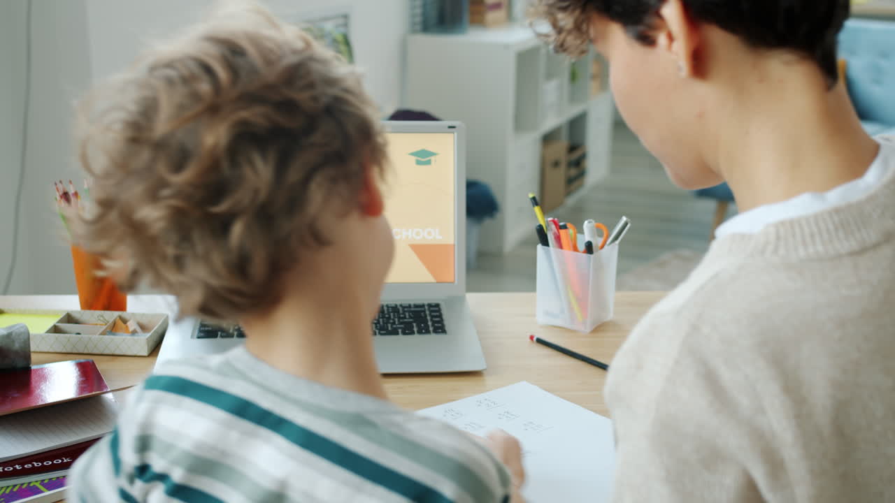 Mother and child doing online school homework
