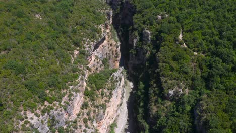 Birds-eye-view-of-deep-gorge-between-steep-and-huge-green-mountains-of-Benje-Canyon