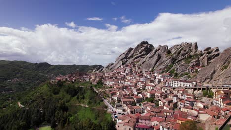 aerial orbit view of pietrapertosa alpine town near rocky mountain, italy