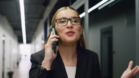 Cheerful-woman-talking-mobile-phone-closeup.-Beautiful-manager-speaking-partner