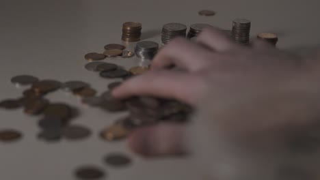 coins being cleaned up off a table from a pile