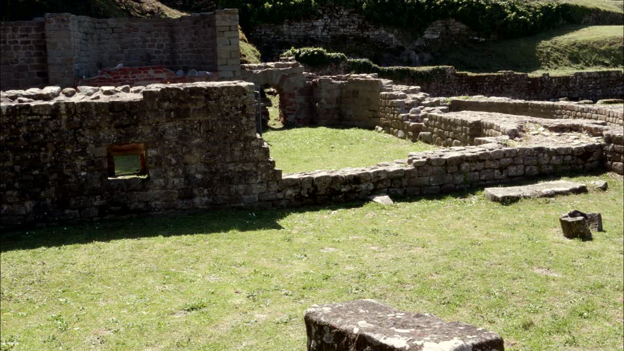 Vista panoramica di antiche rovine in pietra con erba verde