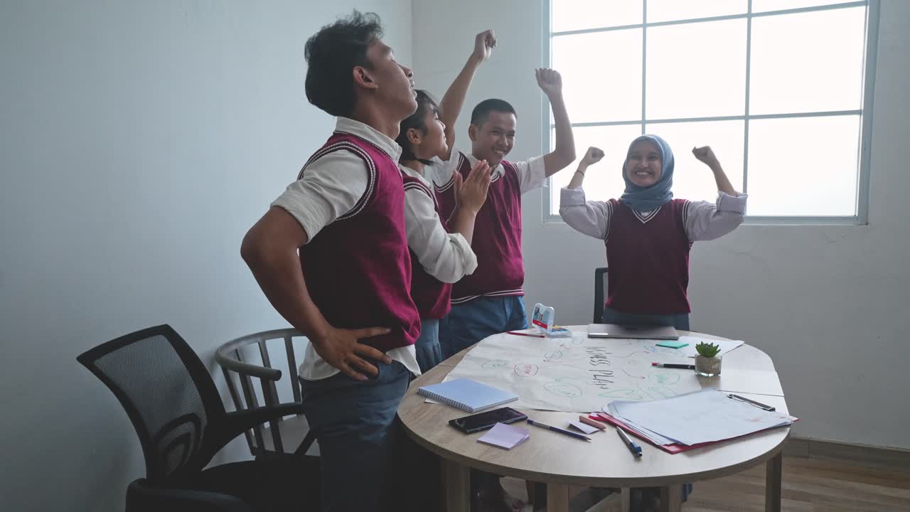 Happy Diverse Asian High School Students Celebrating Achievements, Teamwork And Friendship