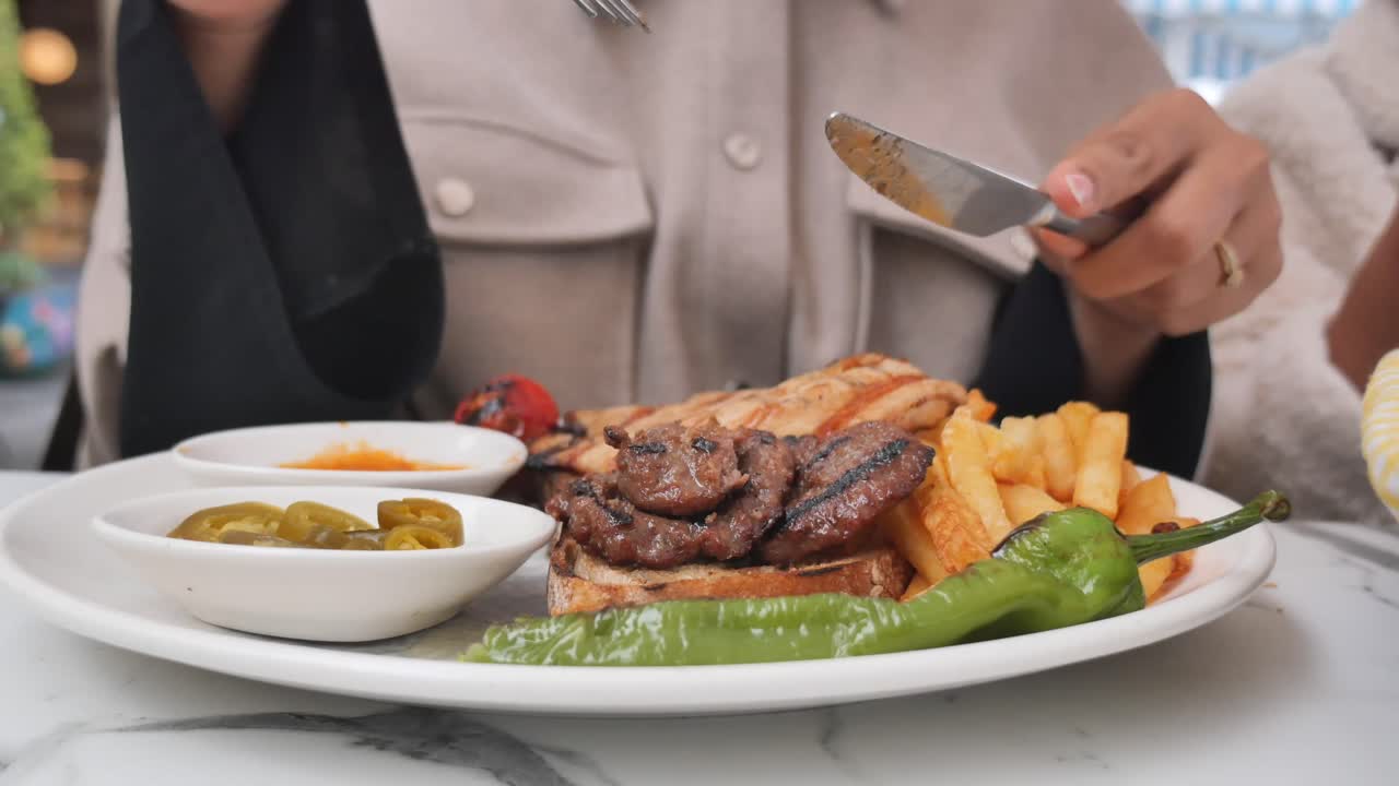 Grilled meat with fries and peppers