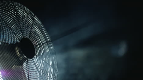 Fan-blades-rotate-in-rays-of-light-and-fog.-Close-up-shot