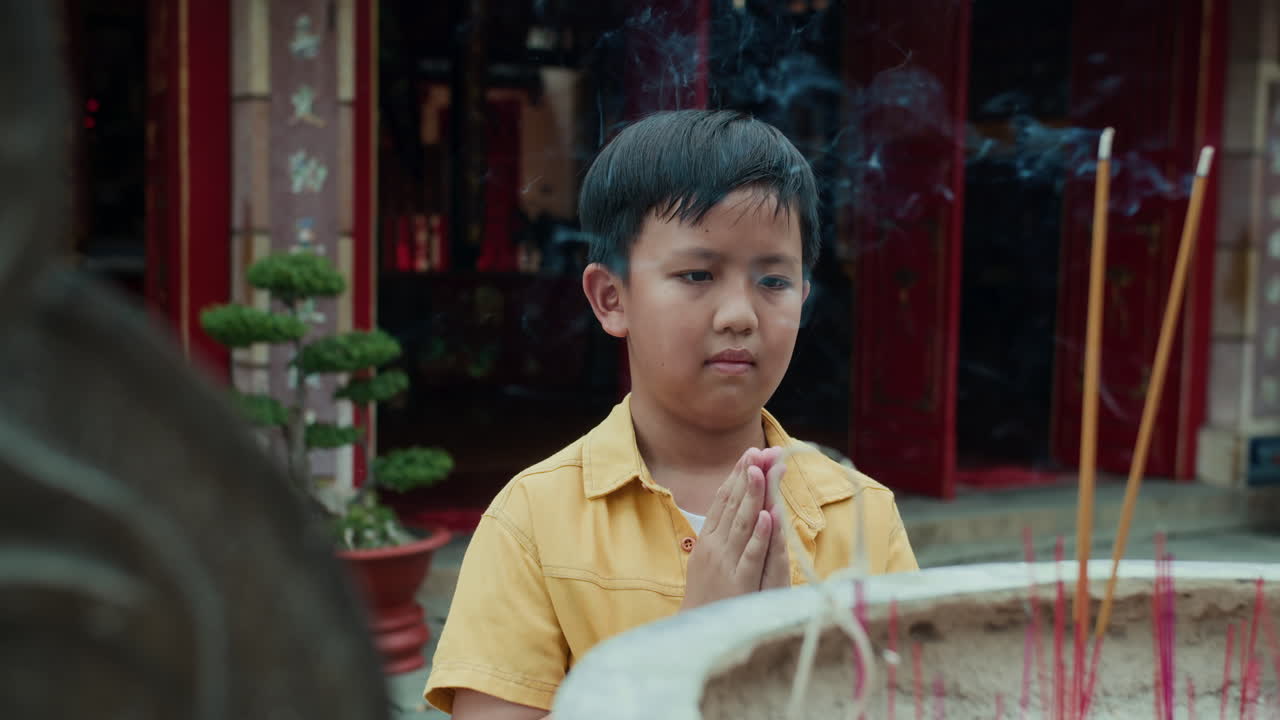 Boy Bowing Down when Praying by Ancient Burner