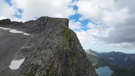 an fpv drone conquers nature's heights, ascending a majestic peak, revealing breathtaking vistas from a soaring perspective