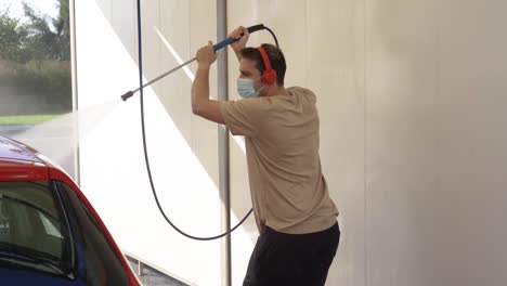 dancing man cleaning the car animated while listening to music and wearing a mask