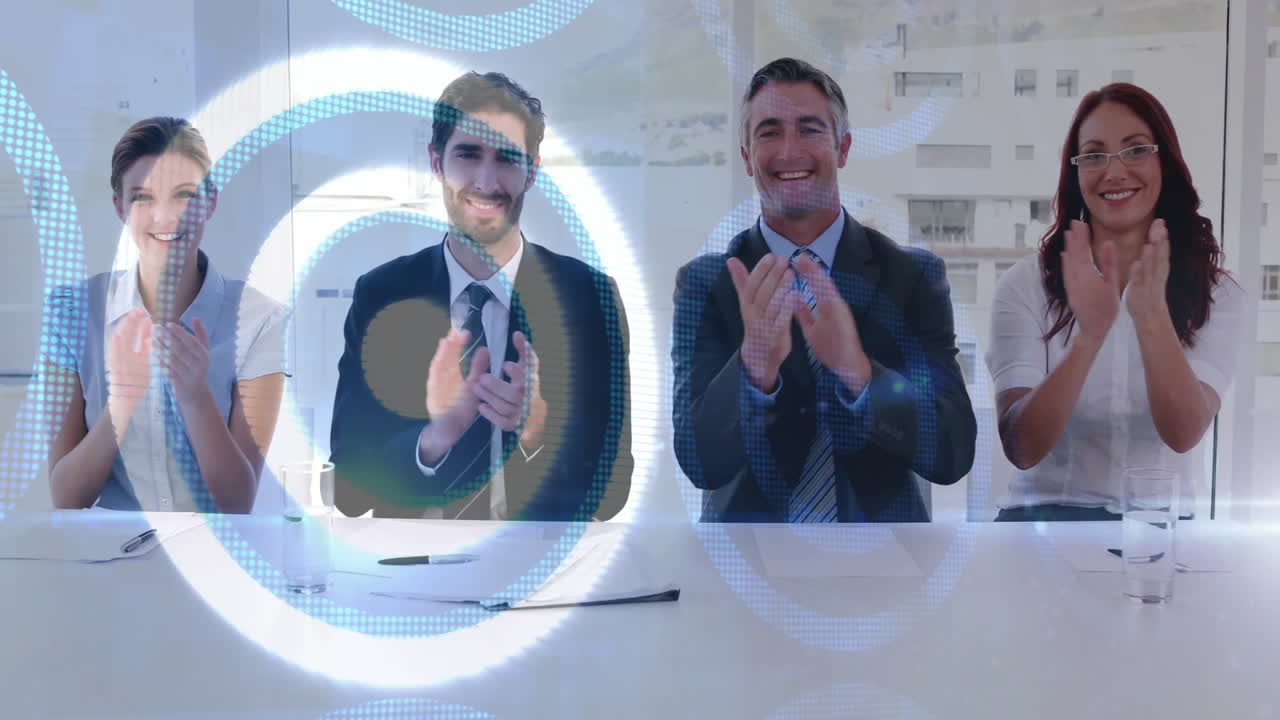 Corporate team applauding in office, featuring circular tech graphics over conference table