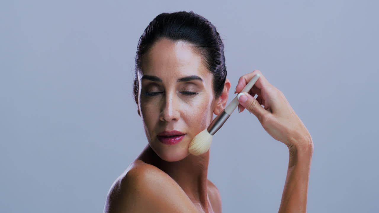 Woman applying makeup with brush
