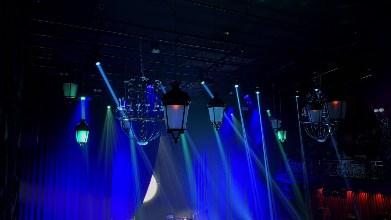 Dynamic 4K footage of colorful stage lights and laser beams moving through a dark nightclub interior, capturing a high-energy entertainment and party atmosphere