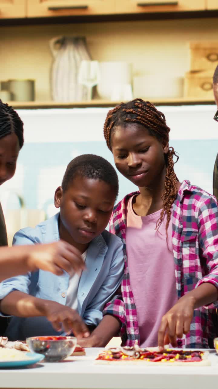 Vertical Video Family cooking homemade pizza together sprinkling ingredients and laughing