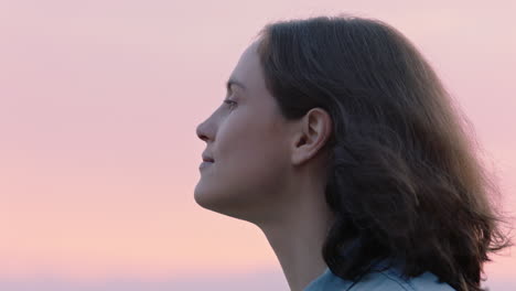 close up portrait of beautiful woman exploring spirituality looking up praying contemplating journey with wind blowing hair in countryside enjoying peaceful sunset