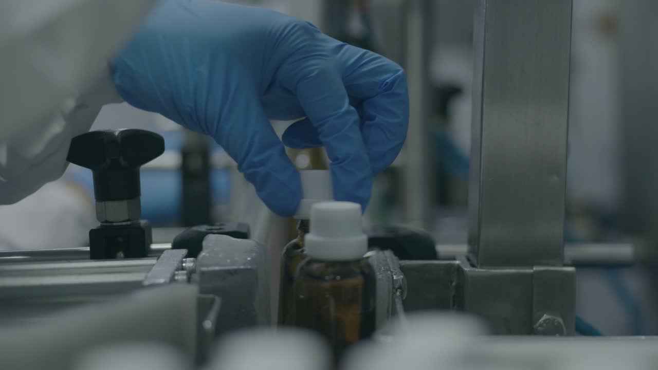industrial machine that seals the medication bottle after the researcher has initially closed it, ensuring secure and proper packaging